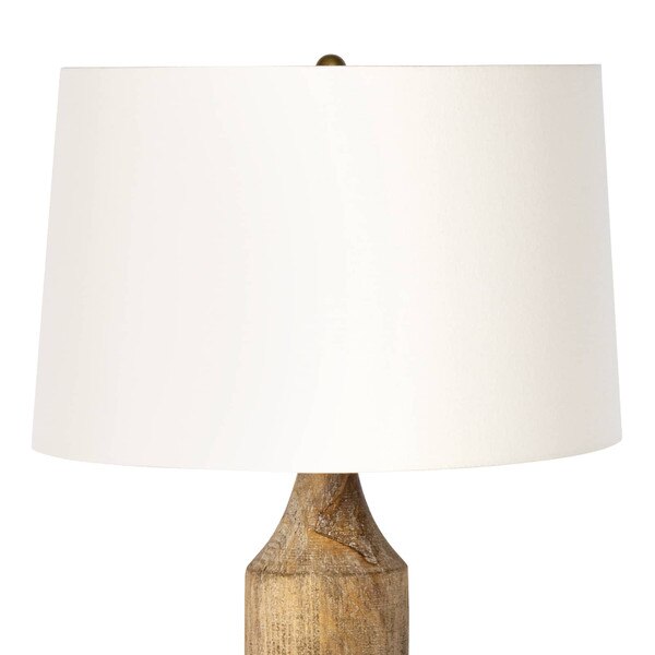 White linen shade of a wood table lamp
